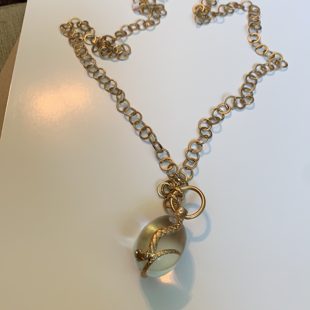 Vintage golden Snake wrapped around an elongated oval crystal